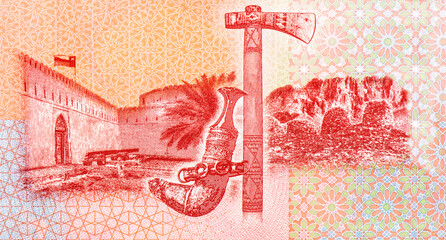 Flag flying over Khasab Castle; Omani khanjar (dagger) and jirz (axe); Wadi Al-Ayn tombs; crossed swords and khanjar. Portrait from Oman 1 Rials 2020,2021 Banknotes.