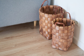 Obraz premium Round wicker baskets made of hyacinth or rattan in the house. Home Decor Concept. High quality photo