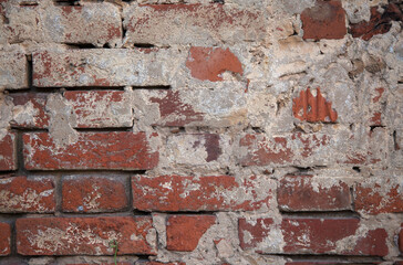 the texture of a red old brick wall with white scuffs and gray cement