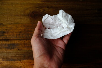 hand with tissue paper.