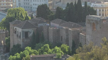 People visit monument in Alcazaba walls, Malaga, Spain