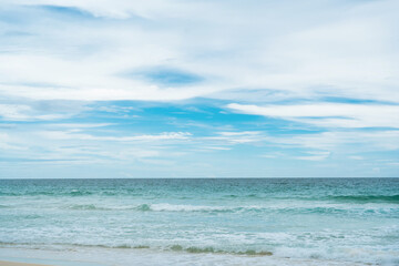 Fototapeta na wymiar beach and blue sky.Landscape waves nature splashes sand beach on sunlight.