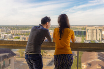couple on balcony looking over the city together