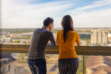 couple on balcony looking over the city together