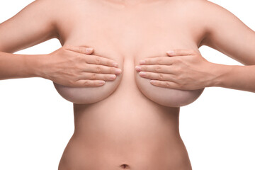 young woman feels her breasts as a precaution.