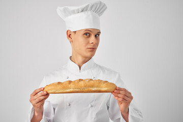 a man in chef's clothes with a baguette in the hands of a gourmet restaurants