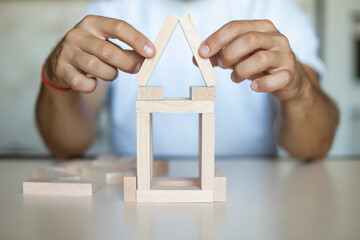 Business man placing wooden block on a tower concept risk control, Risk To Make Buiness Growth...