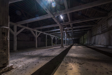 Naklejka na ściany i meble inside dark abandoned ruined wooden decaying hangar with rotting columns