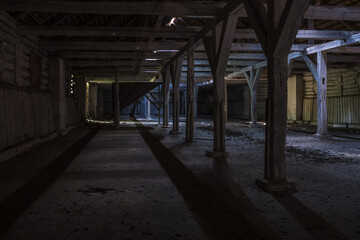 Obraz premium inside dark abandoned ruined wooden decaying hangar with rotting columns