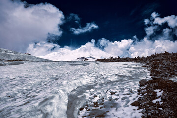 Elbrus area, Greater Caucasus Range. Elbrus, mountains in winter. Mountainous landscape, Elbrus, clouds.