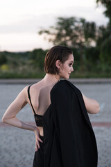 Stylish and attractive Caucasian girl in a suit posing on the street. Fashionable lady. Fashion concept