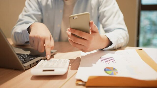 slow motion accounting man hand pressing on calculator for calculate about monthly profit of business for senior accountant job working concept