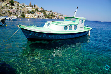 Fototapeta premium small boat in the harbor of symi
