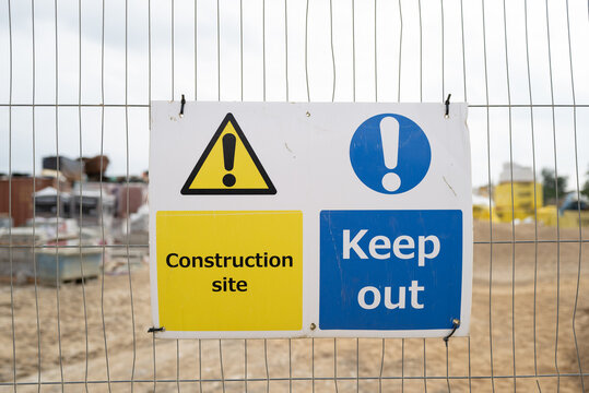 Generic site construction safety sign seen attached to metal safety fencing at the site of a housing development.