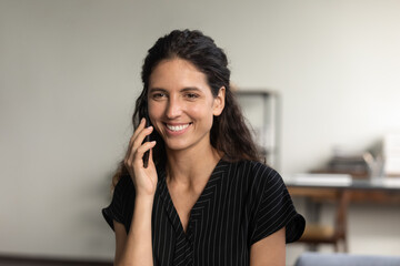 Happy beautiful woman making telephone call from home, talking on cellphone, smiling at good news, enjoying nice conversation. Satisfied customer consulting contact center, making order on phone
