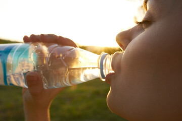 smiling woman drinking water close up nature