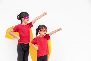 Two girls in a superhero costume on white background