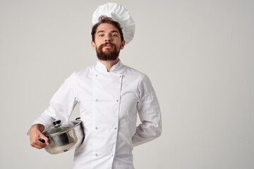 a man in a chef's uniform with a pot in his hands restaurant cooking service