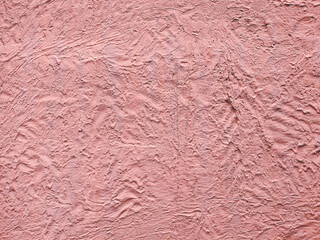 Pink textured stucco wall background