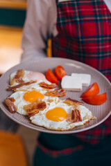 girl holding breakfast on plate
