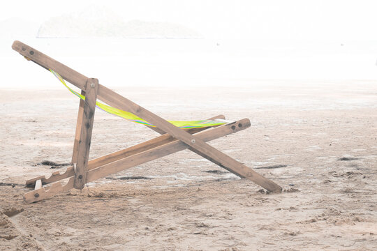 Wooden Chaise Lounge On A Soft White Background On Beach