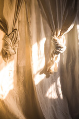 White linen curtain sheet at window with sun light shines on it making beautiful light and shadow texture. Nature and comfort idea design .living with nature concept