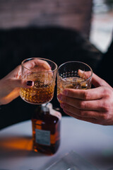 toasting with glass of whiskey