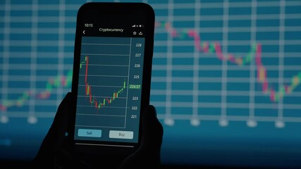 a professional broker looks at a detailed chart of cryptocurrency price changes on the screen of a mobile phone against the background of other charts of the stock exchange - Powered by Adobe