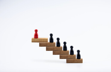 wooden doll in a hierarchy of wooden blocks. The concept of raising the level of individuals in the...