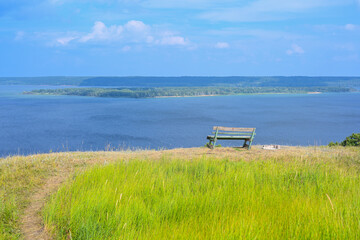 A lonely bench on a mountain with a beautiful view of the Volga River. A place for solitude,...