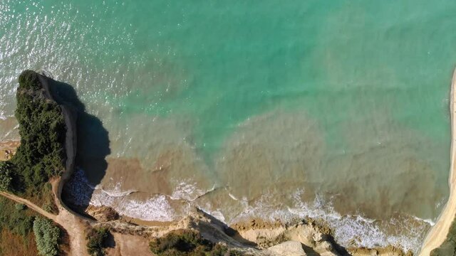 Aerial view Channel of love in Corfu island, Greece. Drone slowly descends over swimming tourists, top-down slider shot.