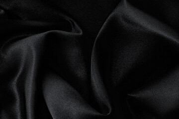 abstract texture of draped black background. eautiful textile backdrop. Close-up. Top view