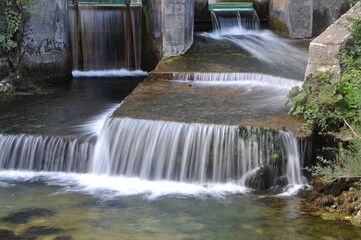 Small waterfall in the forest. Small stream waterfall on spring forest.