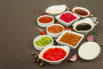 Set of different sauces - ketchup, mayonnaise, barbecue, soy, chutney, wasabi, adjika, horseradish