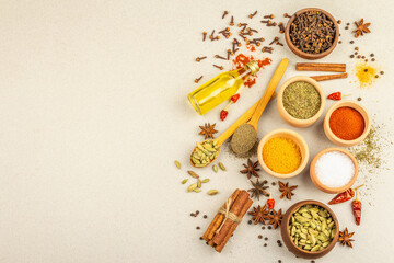 A set of spices for cooking curry. Aromatic condiments on light stone concrete background - obrazy, fototapety, plakaty