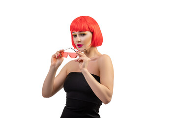 Portrait of young beautiful girl wearing red wig and fancy make-up isolated on white background