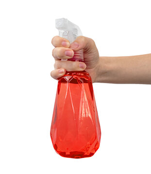 Hand with red spray bottle with water, isolated on w ahite background photo