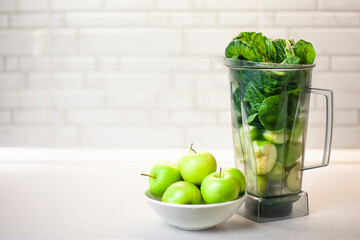 green set of products for a healthy smoothie was put in a blender: lemon, apple, avocado, spinach. Morning detox for a healthy lifestyle, weight loss, ketone diet, raw food diet