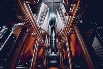 Rows of steel tanks for beer fermentation and maturation in a craft brewery - obrazy, fototapety, plakaty