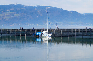 a beautiful marina of Lindau island on lake Constance with the Alps in the background on a sunny day in March