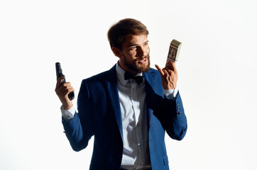 male gangster with a gun in hand light background