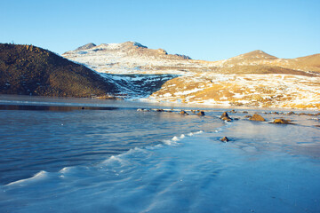 ice lake and hill in winter