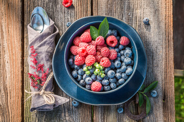 Napkins, cutlery and berries in summer garden.