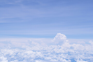 Aerial view of clouds and sky as seen through the window of an aircraft