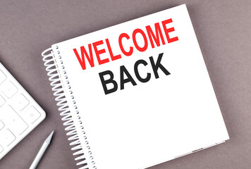 WELCOME BACK text on notebook with calculator and pen