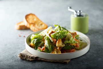 Traditional homemade Caesar salad with salmon