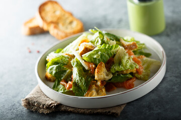 Traditional homemade Caesar salad with salmon