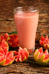 Homemade delicious red guava fruit smoothie juice served in glass, cold, chilled drinks background.