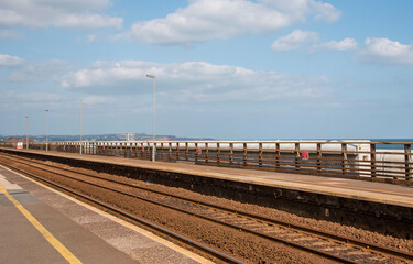 Devon, England, UK. 2021.  Railway tracks passing through a west country coastal station.