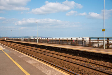 Fototapeta na wymiar Devon, England, UK. 2021. Railway tracks passing through a west country coastal station.